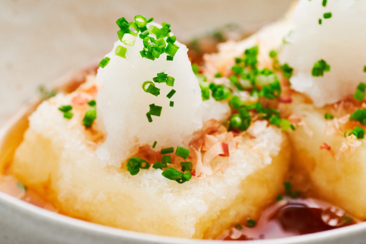 Agedashi tofu served with scallions, katsuobushi (shaved skipjack tuna), and grated daikon radish.