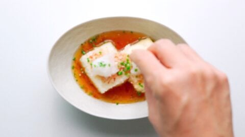 Sprinkling scallions on agedashi tofu.