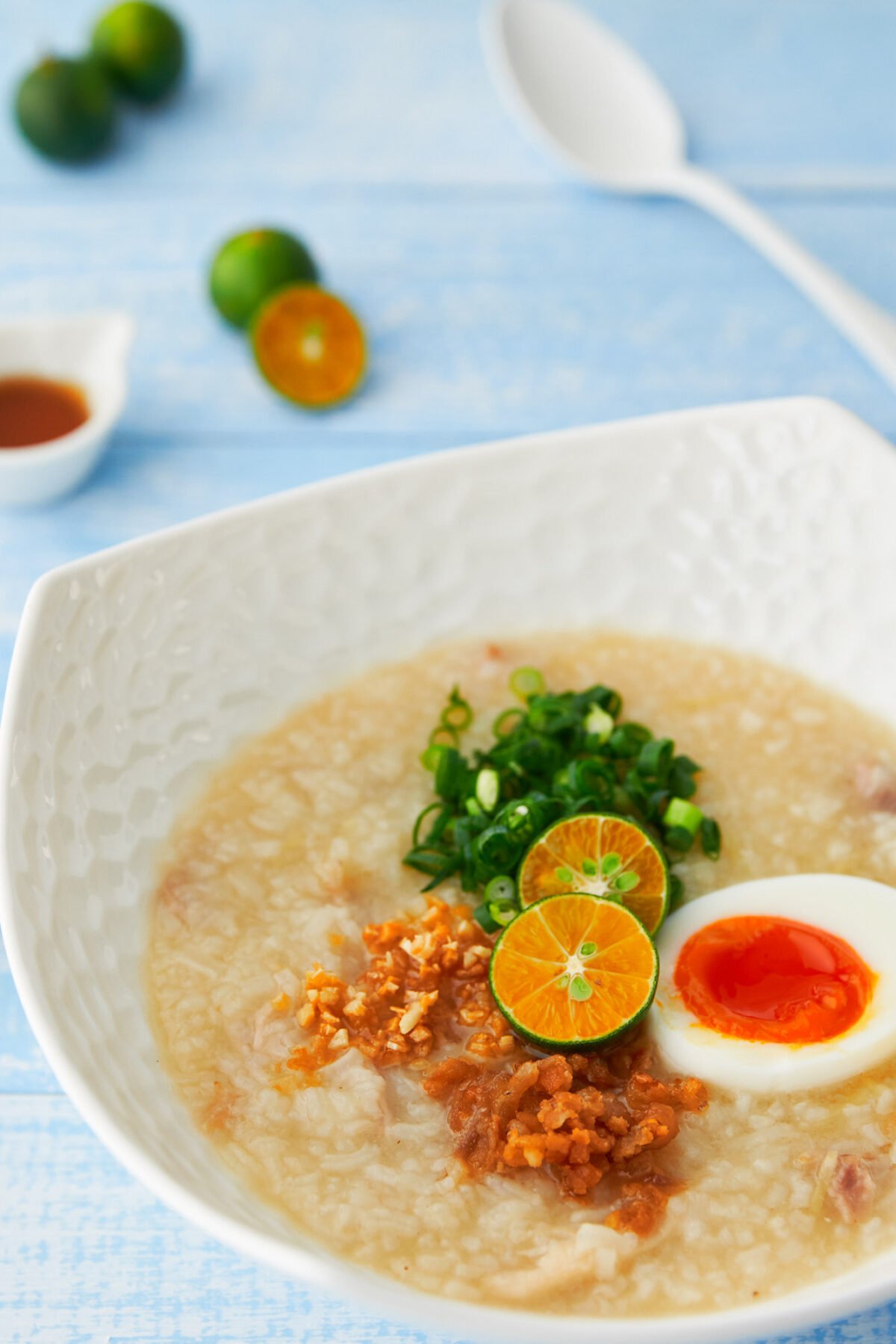 Arroz Caldo is a creamy chicken and ginger rice porridge with a mouthwatering array of contrasting condiments to go on top.  The perfect way to add some warmth and sunshine to a wintery day.