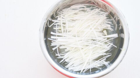 Julienned scallions soaking in water to tame them.