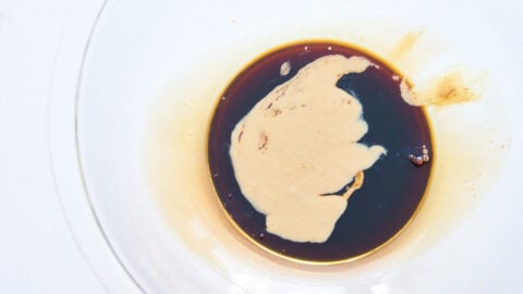 Sesame paste, black vinegar and soy sauce in a glass bowl to make the sauce for bang bang chicken.