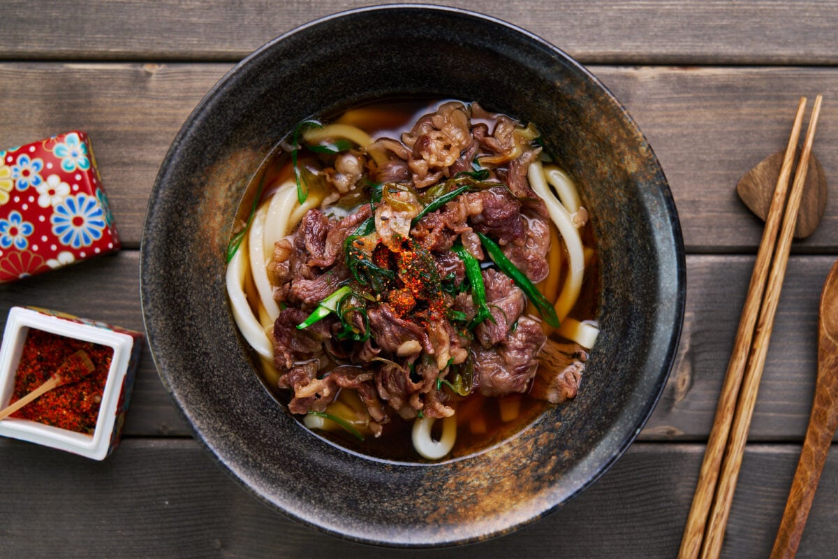 Beef Udon (a.k.a. Niku Udon) is an easy Japanese comfort food made by topping a steamy bowl of udon noodle soup with beef simmered in a savory sweet sauce.