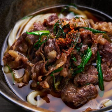 This easy bowl of Niku Udon (Beef Udon) is a comforting bowl of noodle soup topped with tender slices of beef simmered in a savory-sweet sauce with scallions.