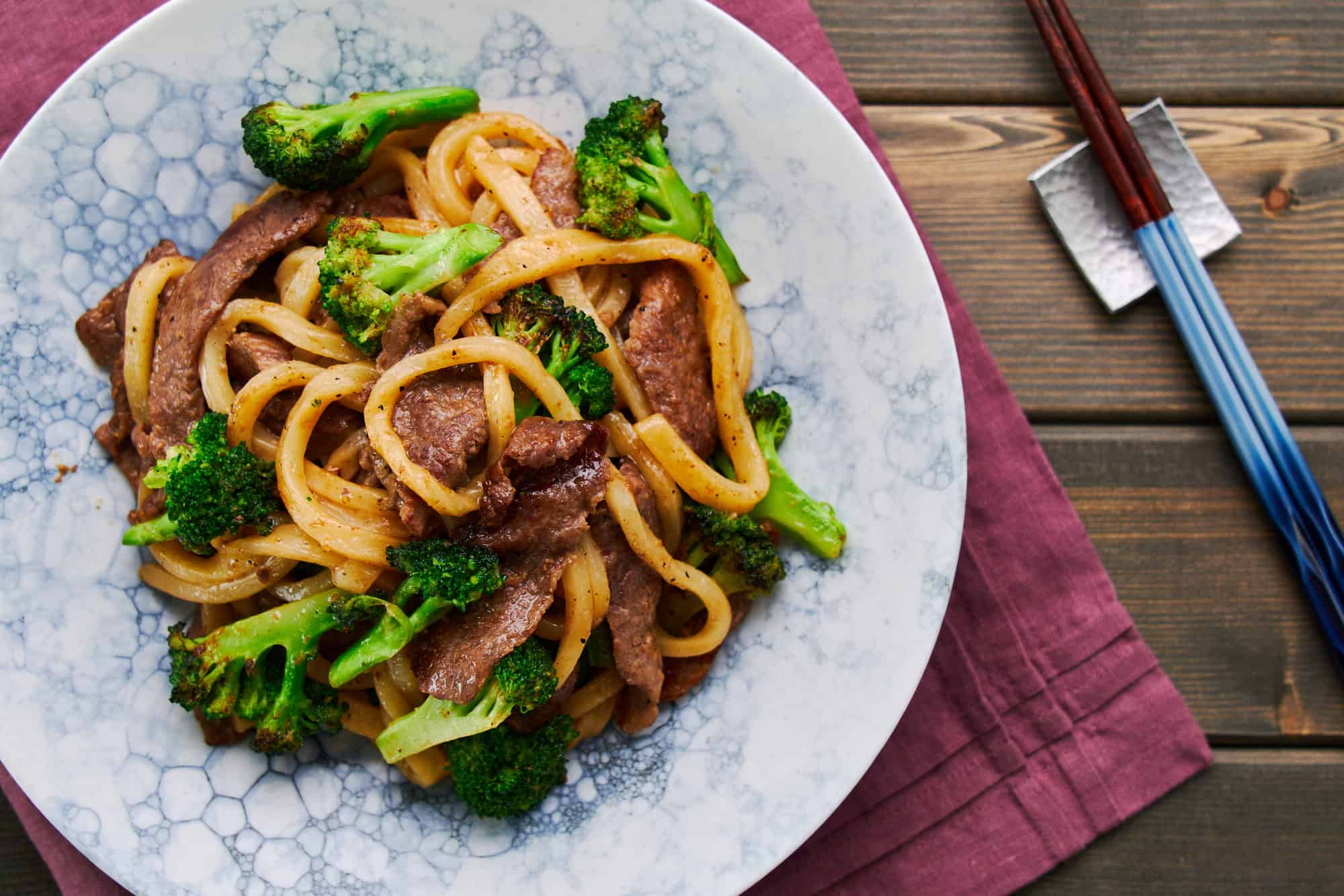 Overhead view of a plate of Japanese Beef Yaki Udon (stir-fried noodles).