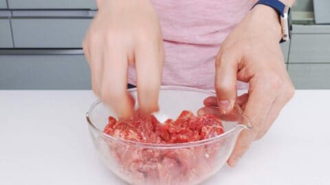 Marinating thinly sliced beef with ginger, garlic, soy sauce, and sake.