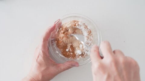 Mixing sugar, spice and starch mixture for apple pie filling.