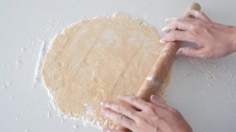 Rolling out flaky all-butter pie crust for apple pie.