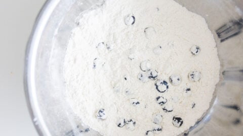 Tossing the blueberries with the dry ingredients first helps them mix into the pancake batter better.