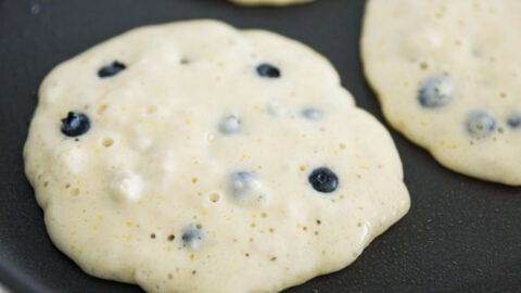 Bubbles rising to the surface indicate the pancakes are ready to flip