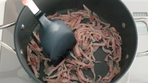 Sautéing Guanciale with olive oil to make Amatriciana sauce.