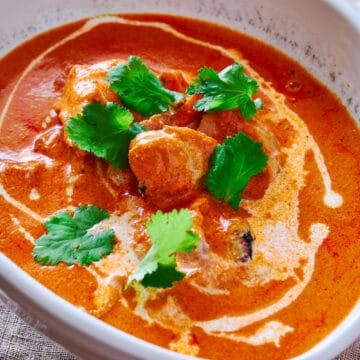 Experience the irresistible allure of my butter chicken recipe, showcasing tender chicken pieces swimming in a luxuriously smooth and flavorsome sauce.