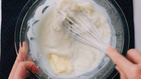 Whisking butter into hot mochi batter.