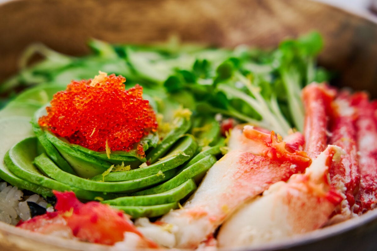 This mouthwatering California Bowl has avocado, crab, and tobiko served on a bed of sushi rice.