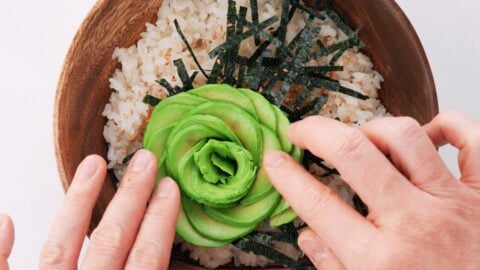 Avocado rose blooming on a sushi bowl.