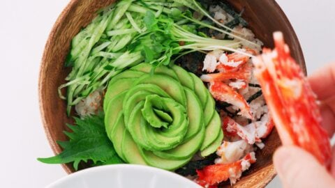 Avocado and crab on top of sushi rice.