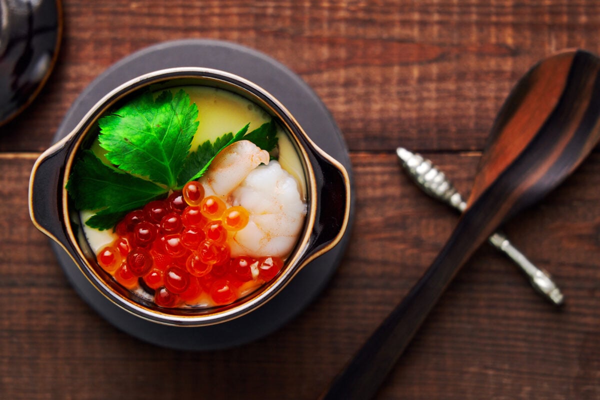 Chawanmushi (Japanese Steamed Egg) topped with ikura, shrimp, and mitsuba leaves.