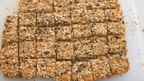 Savory granola cut into square granola bars on a cutting board.