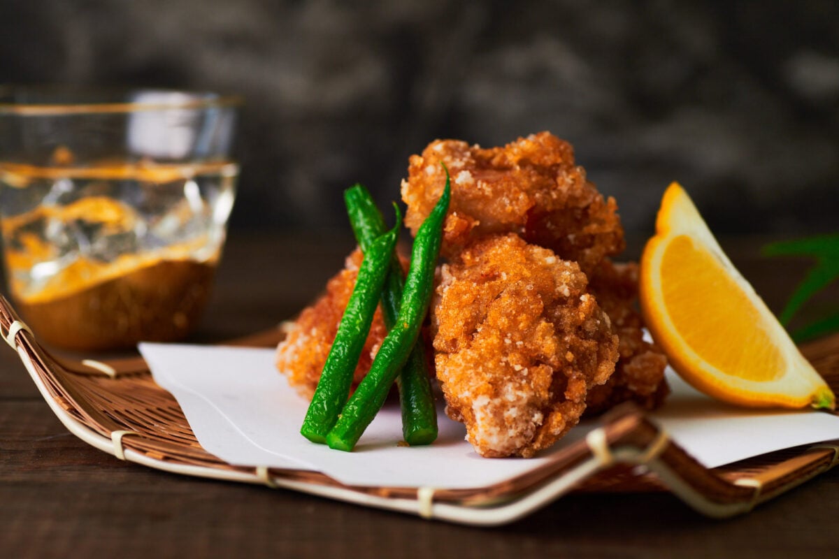 Crisp Chicken Karaage with green beans and a wedge of lemon.