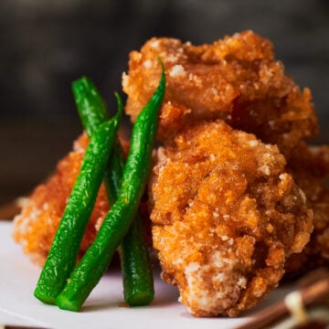 Crisp Chicken Karaage with green beans and a wedge of lemon.