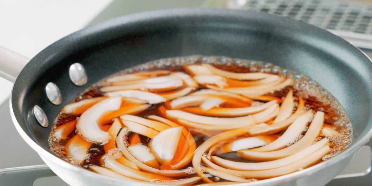 Onions simmering in dashi broth.