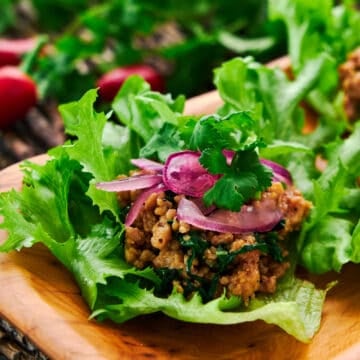 Close-up of vibrant Asian Chicken Lettuce Wraps showcasing the tender ground chicken and basil filling.