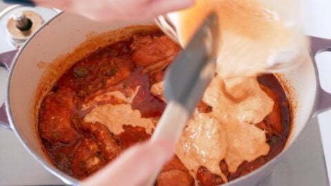 Sour cream roux being added to chicken paprikash