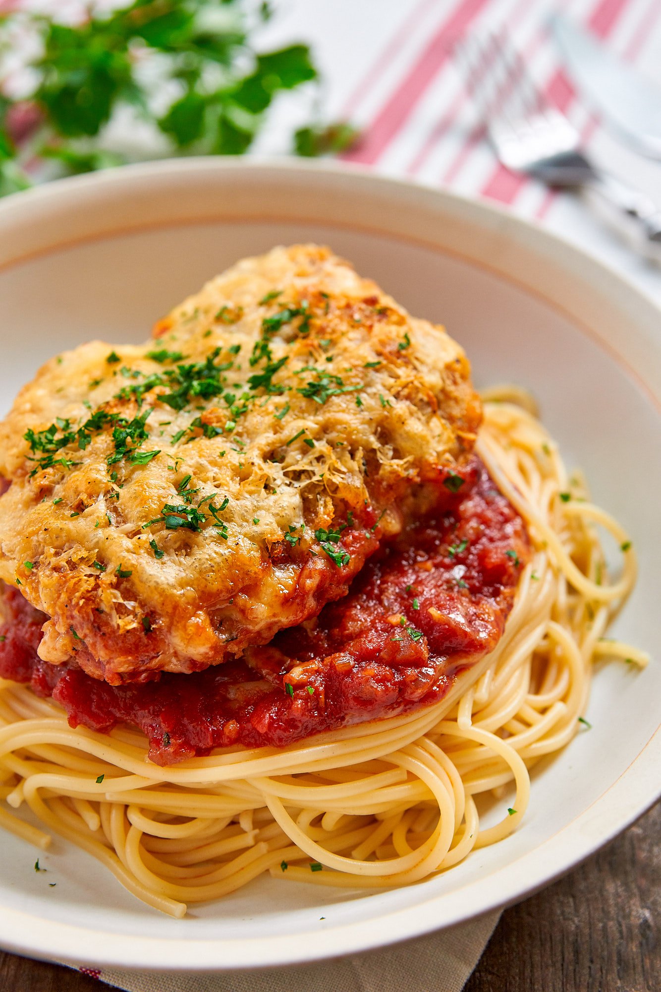 Crisp on top and saucy on the bottom you'd never guess this easy Chicken Parmesan recipe was baked.