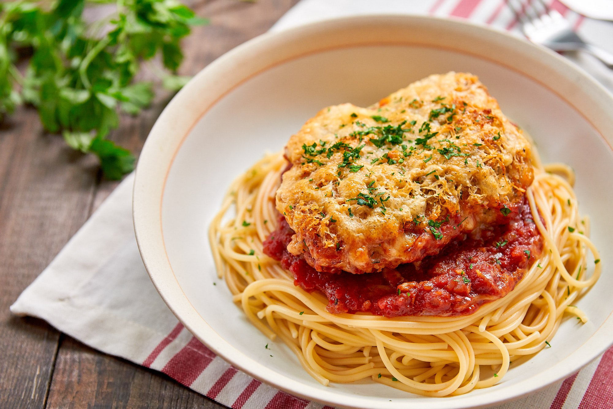 With crisp seasoned breadcrumbs and cheese on top and savory sauce on the bottom, this easy chicken parmesan is irresistably good.