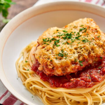 Crisp on top and saucy on the bottom you'd never guess this easy Chicken Parmesan recipe was baked.