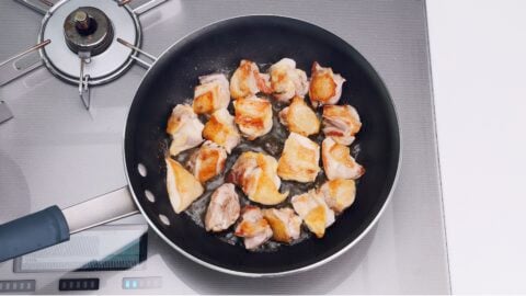 Browned chicken in a frying pan.