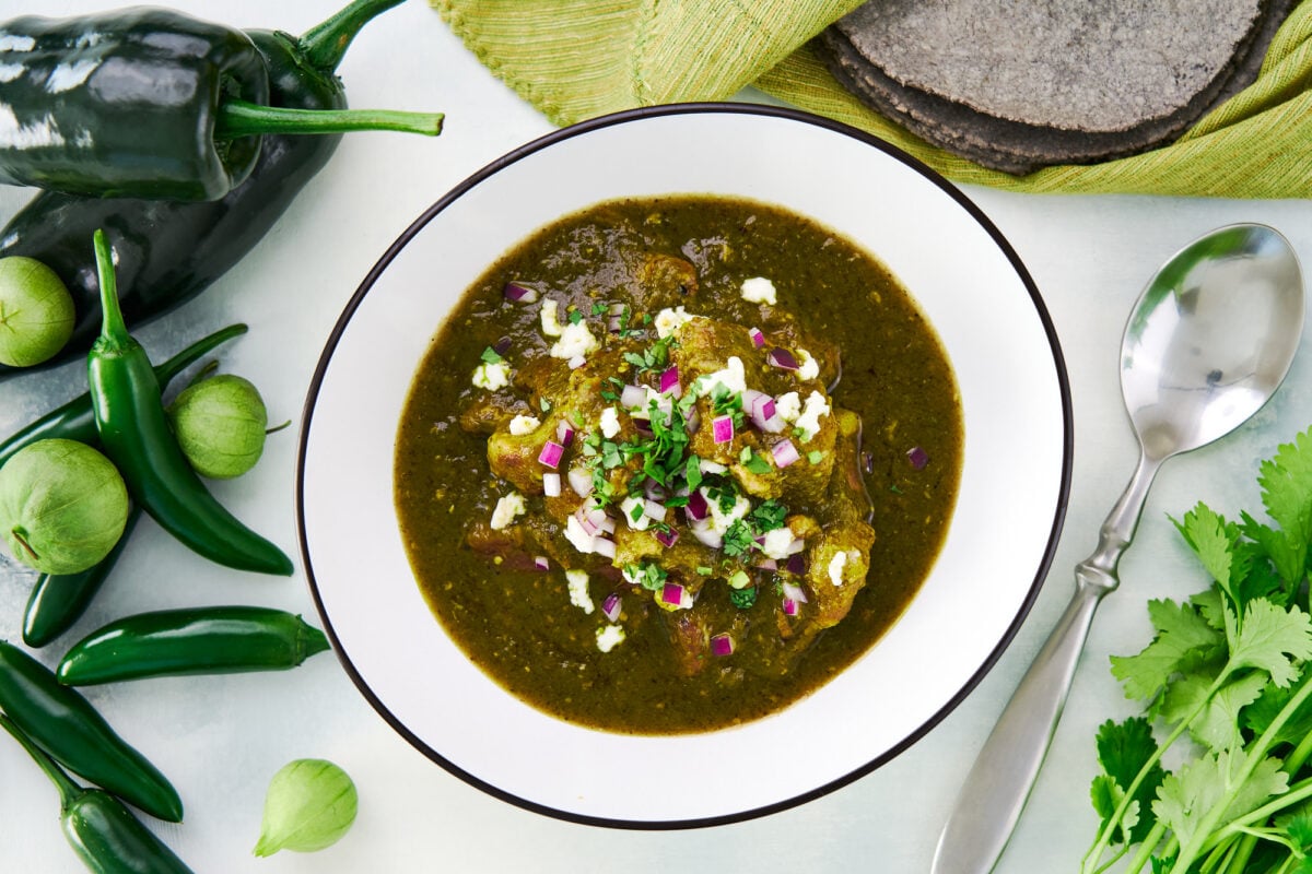 Overhead view of a big bowl of Chile Verde (Green Chili) made with pork, green peppers, and tomatillos.