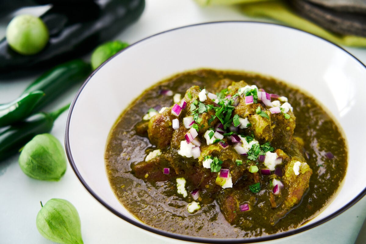 Fork-tender chunks of pork shoulder braised in a tangy sauce made from char-roasted green chiles and tomatillos. Garnished with queso fresco, cilantro and red onions.