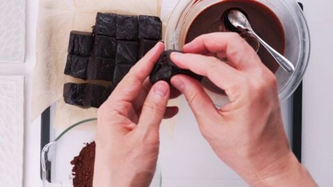 Stuffing chocolate mochi with ganache.