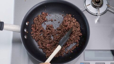 Browning beef in a frying pan.