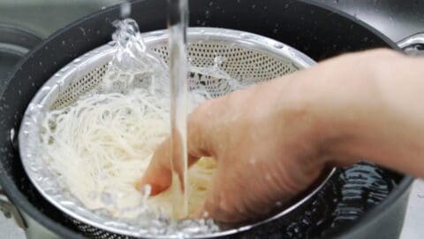 Chilling somen noodles in cold water.