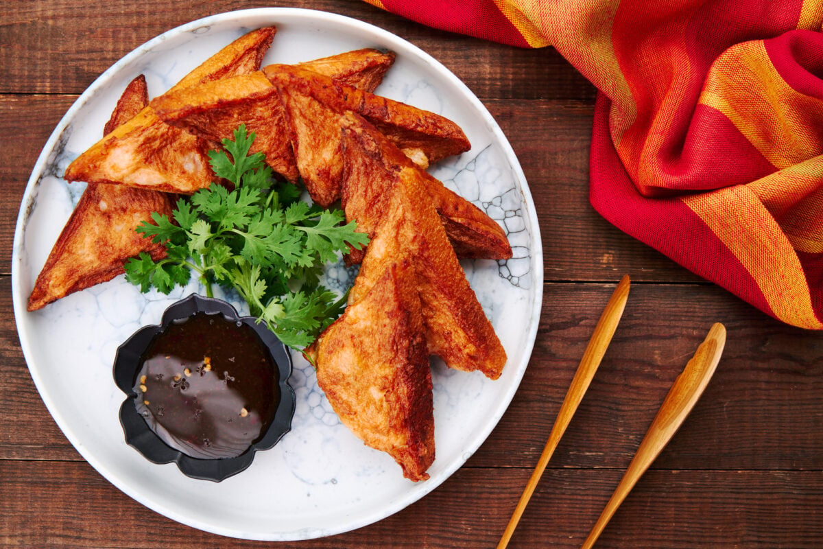 A plate of Shrimp Toasts with sweet chili dipping sauce.