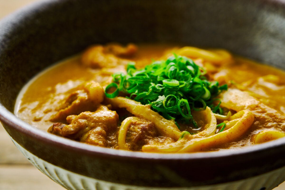 Chicken and udon noodles in a Japanese-style curry broth garnished with scallions.