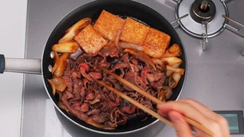 Simmering thinly sliced beef for making a Demon Slayer Beef Bento.