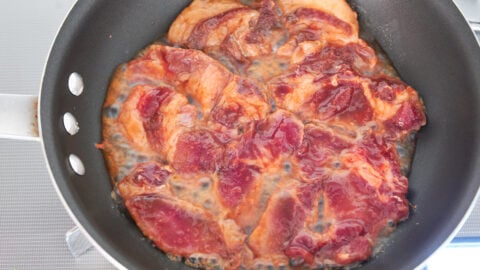 Cooking Tocino, or Filipino bacon in a frying pan.