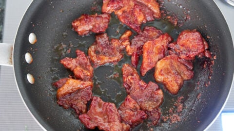 Fried Tocino in a pan made with natural coloring and cured with celery juice.