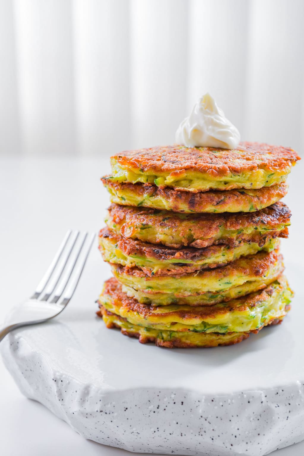 Fluffy zucchini pancakes with caramelized scallions and Gruyere cheese are tender, flavorful and delicious.