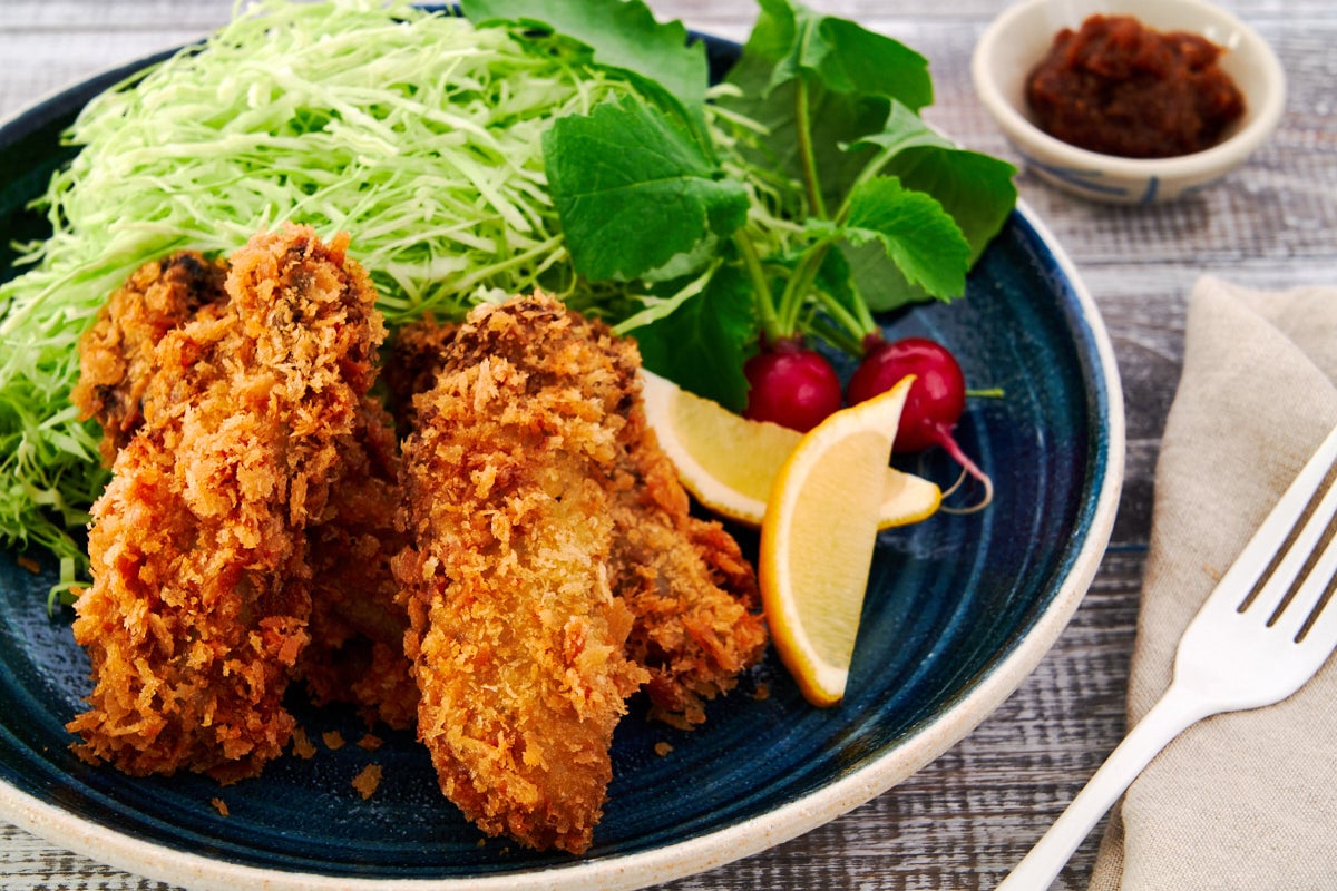 A plate of Kaki Fry, or Japanese Fried Oysters with an ultra-crispy panko crust and plump briny center.