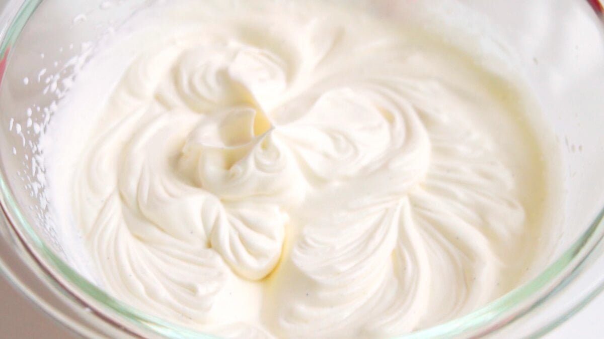 Whipped cream in a glass bowl for fruit sandwiches.