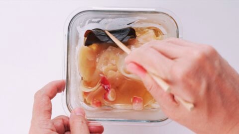 Pickling ginger in vinegar, sugar, and salt to make sushi ginger.