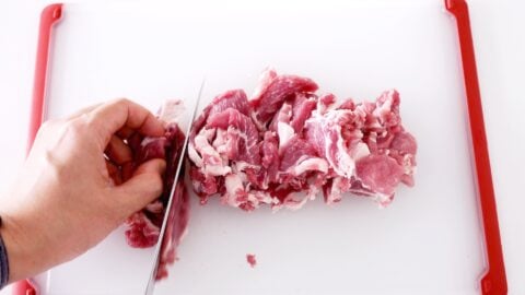 Slicing pork shoulder thinly for making Japanese Ginger Pork.