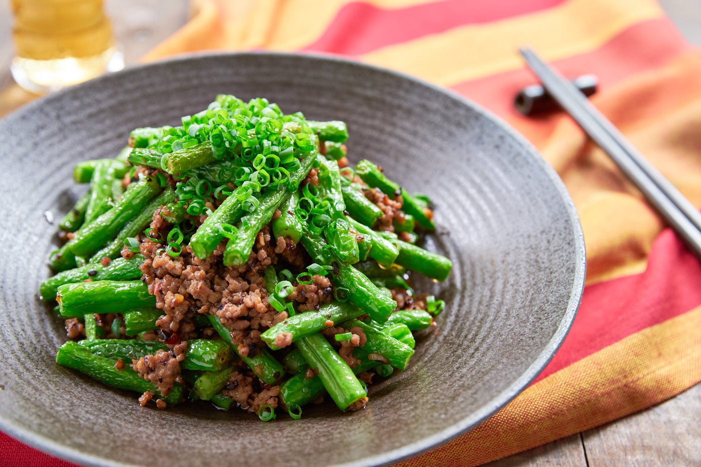 This delicious green bean stir-fry comes together in just mimnutes and yet it's loaded with tender green beans and ground pork seasoend with garlic, black beans and chili paste.