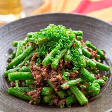 This delicious green bean stir-fry comes together in just mimnutes and yet it's loaded with tender green beans and ground pork seasoend with garlic, black beans and chili paste.