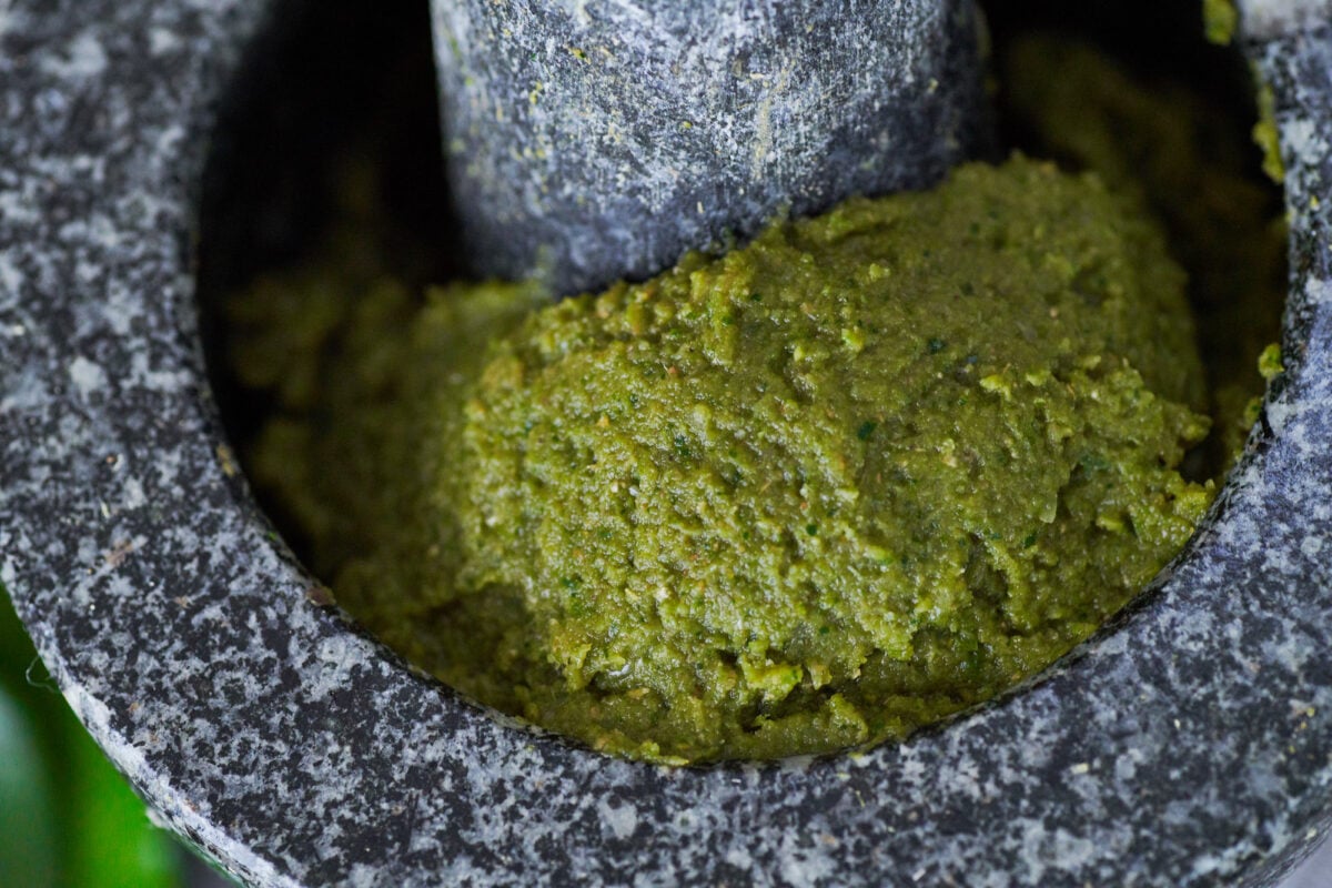 Learn how to make this fragrant Thai green curry paste made from green chilies, lime leaves, lemongrass, shallots, garlic, and spices.