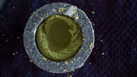 Green curry paste in a mortar.