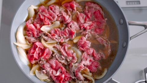 Adding thinly sliced beef to the onions and dashi stock makes the best gyudon.